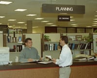 Office workers discussing and planning permits