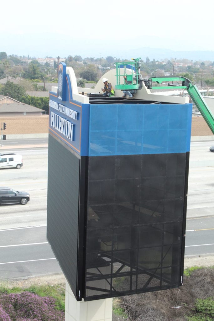 Encore Image team working on display sign for CSUF